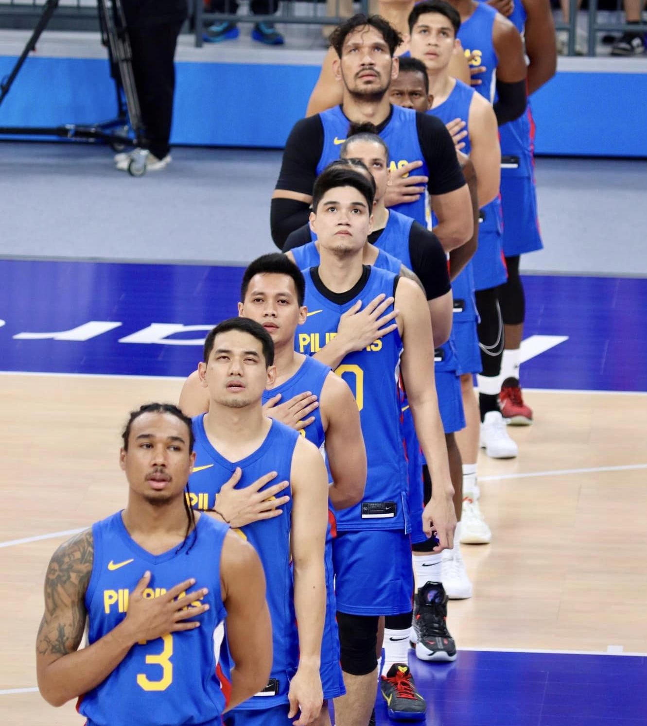 Gilas Pilipinas singing the national anthem before the gold medal match against Jordan in the 19th Asian Games men's basketball tournament.
