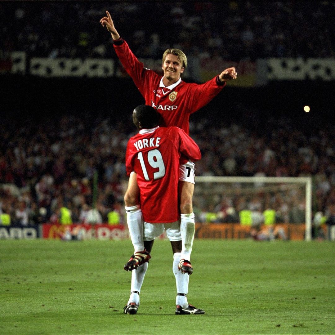 David Beckham lifted by Dwight Yorke in a Manchester United game