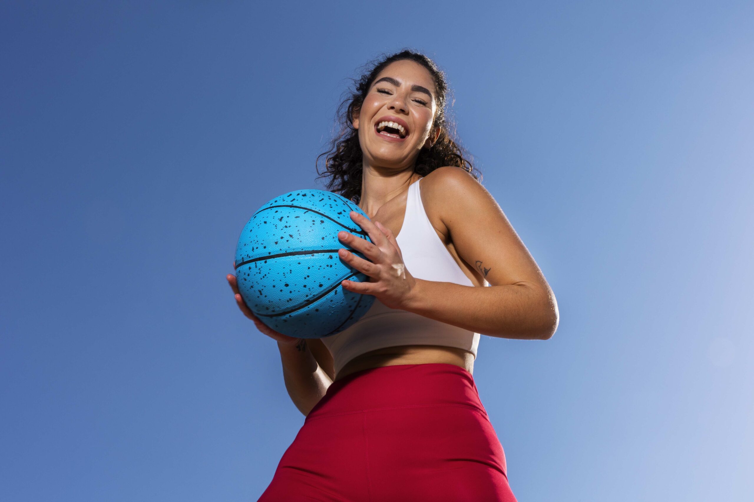 Woman athlete holding basketball