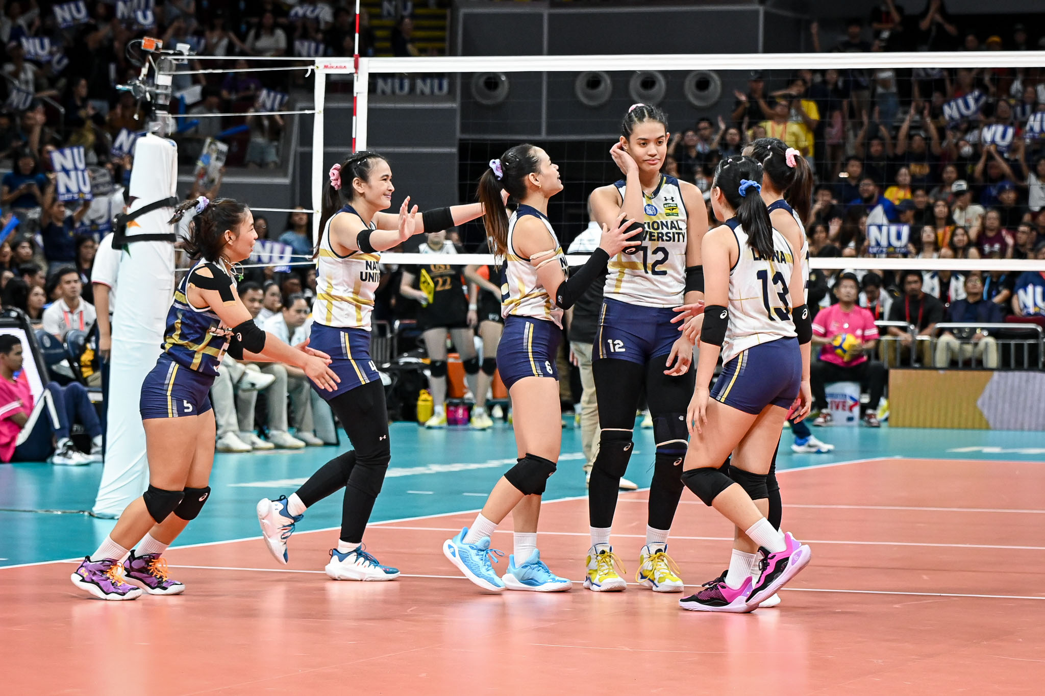 NU celebrates during the UAAP women's volleyball finals against UST