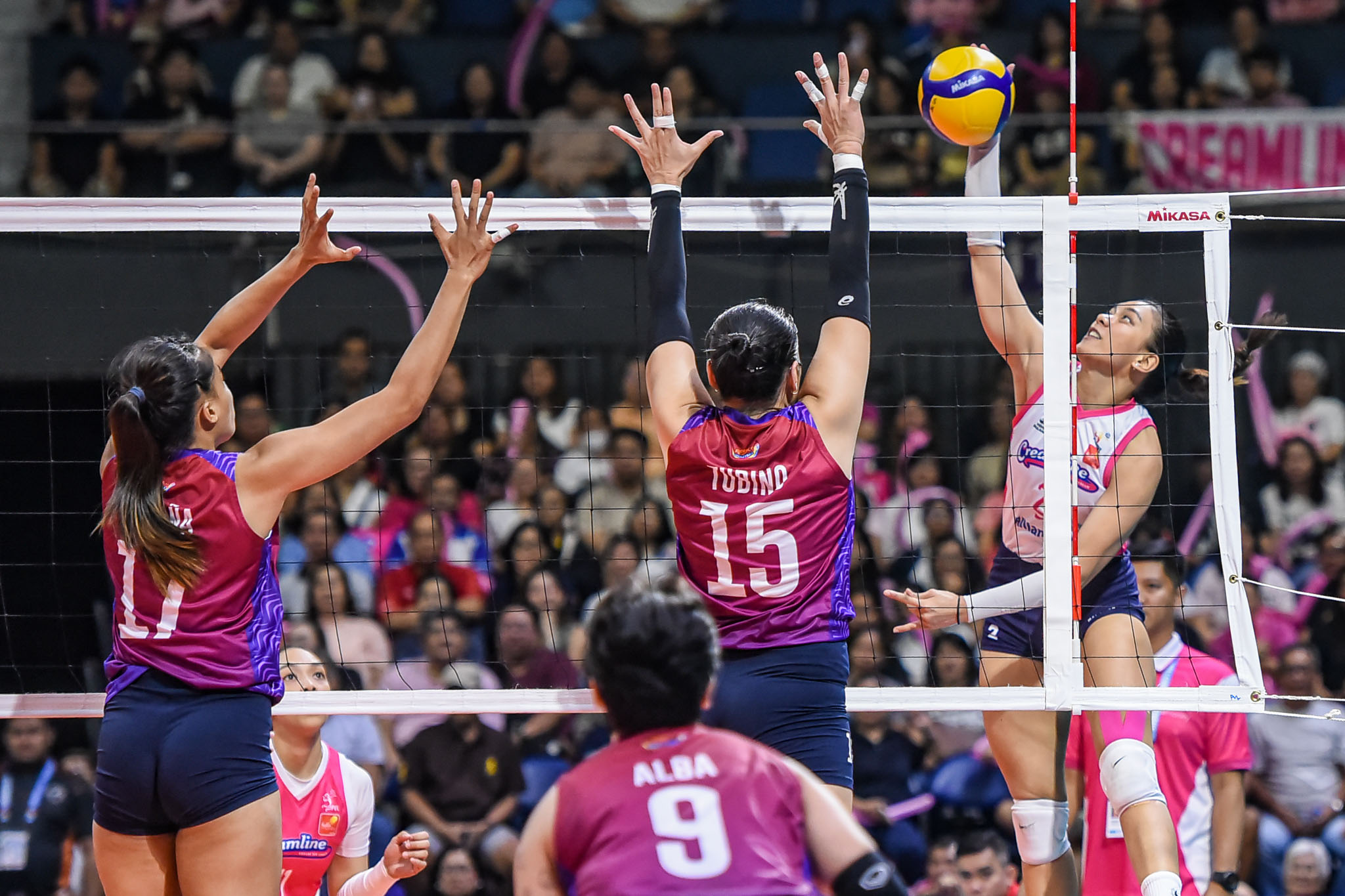 Pvl afc 25 creamline vs choco mucho - alyssa valdez-1510 - the game A shot of Alyssa Valdez going over a double block by Choco Mucho's Royse Tubino and Lorraine Pecaña