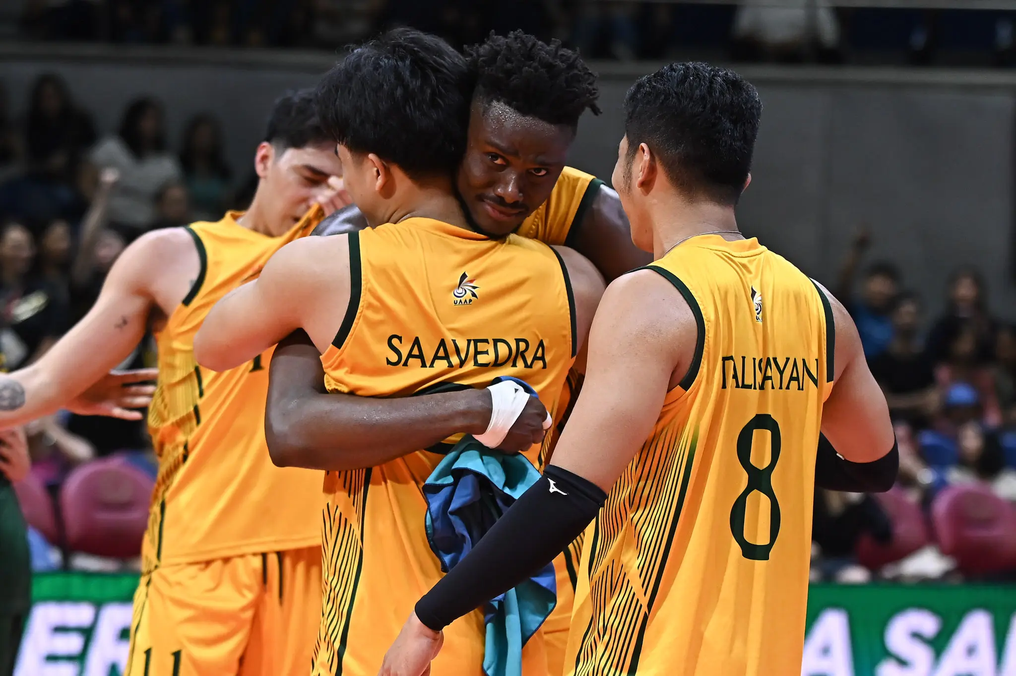 Middle blocker Doula Ndongala shares an emotional hug with senior Dryx Saavedra